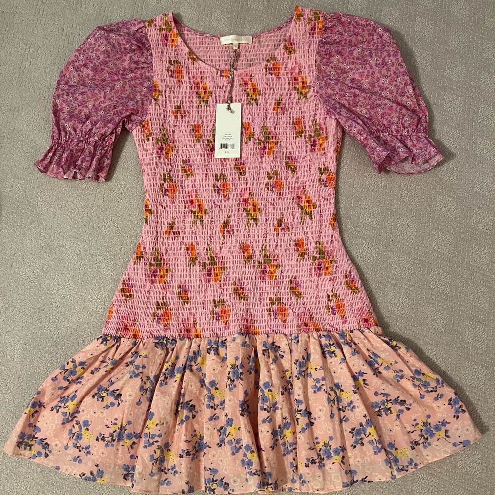 LoveShackFancy dress that is Brand New with tags. Pink with varied patterns.